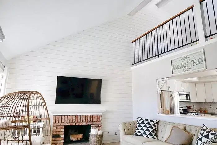 white accent wall with tv for living room
