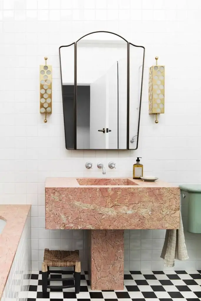 Highlighting the tub and pedestal sink with decorative tile