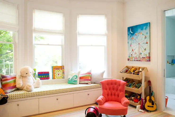toys stored in large bay window in a childrens playroom in a large ADKR