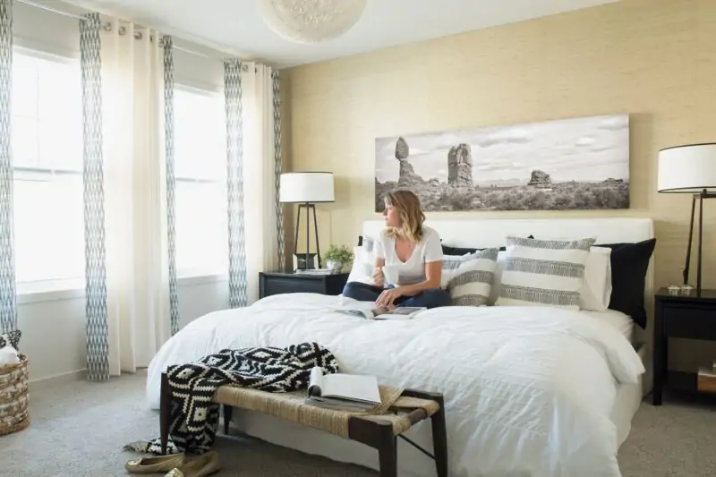 woman sitting on bed with cup of coffe