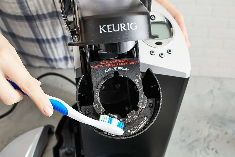 Step clean the coffee maker with brush
