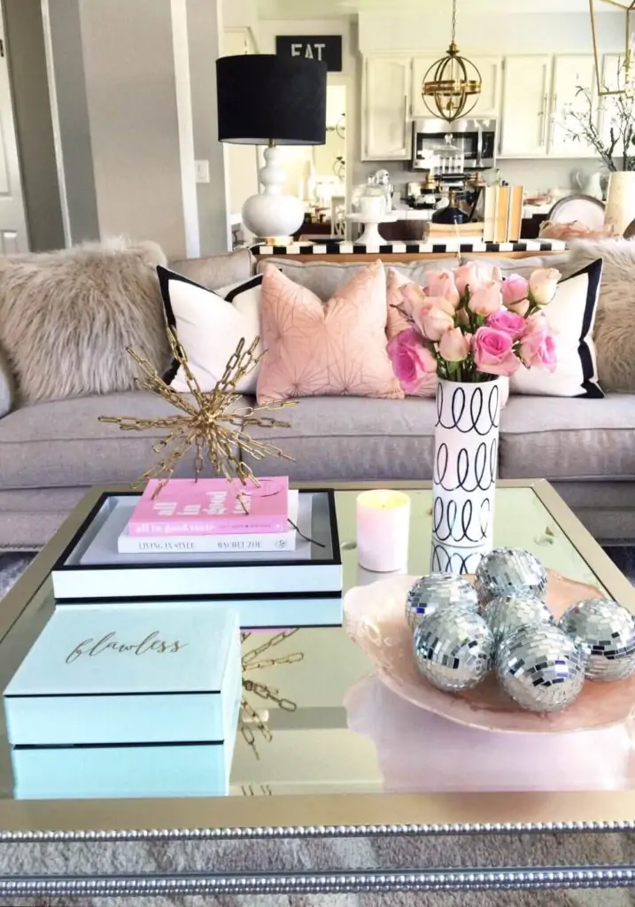 coffee table decorating idea with pink accent in bw room