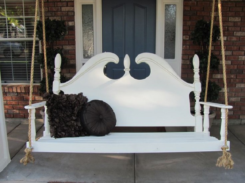 antique style daybed swing on the front porch