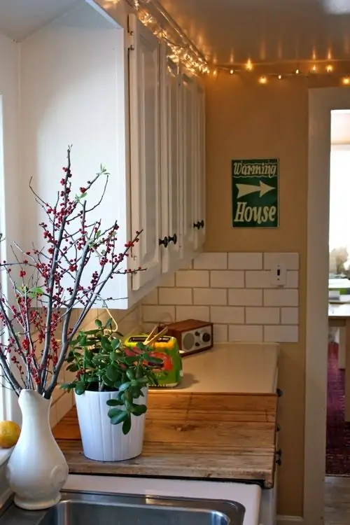 twinkle lights above the kitchen cabinets