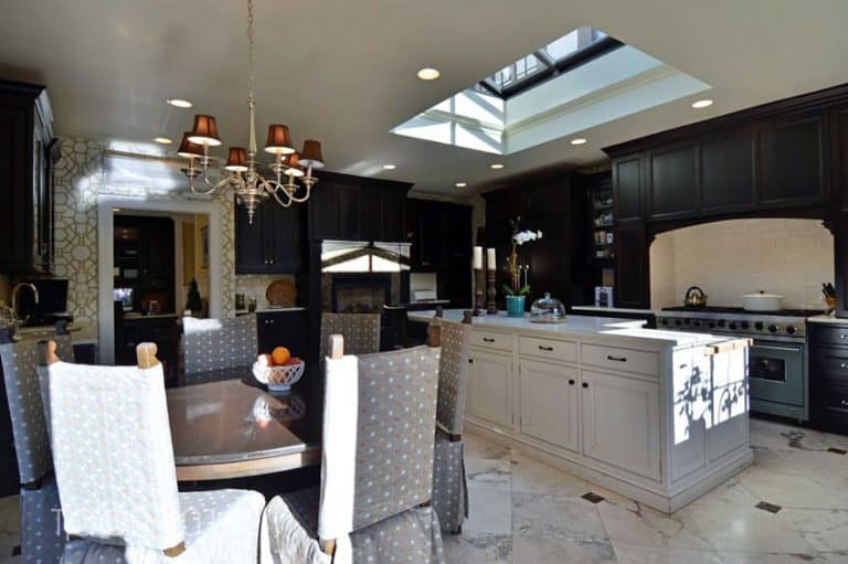 dark wood cabinet kitchen with white island and skylight