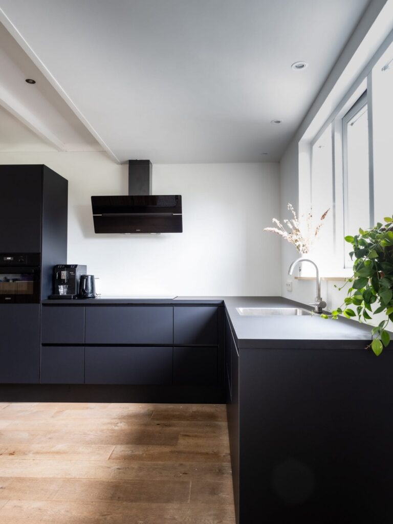 Black minimalistic kitchen cabinets without upper cupboards
