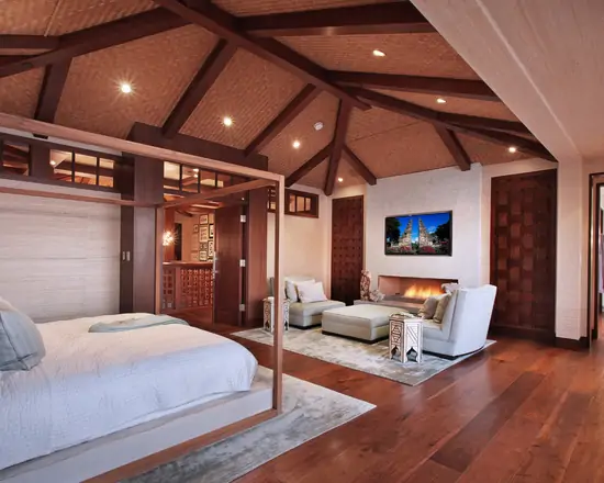 luxury master bedroom with sitting area and TV