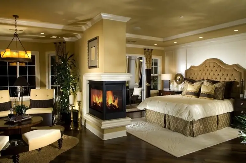 master bedroom with fireplace in center