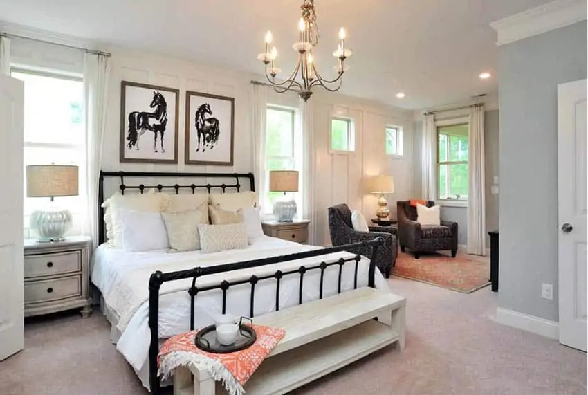 white bedroom with beige carpet and black sitting area