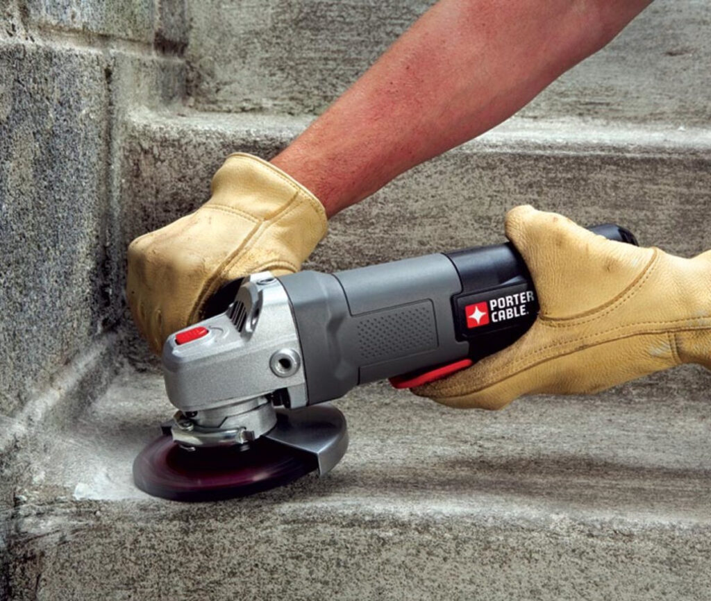 Sand concrete floor with hand sander