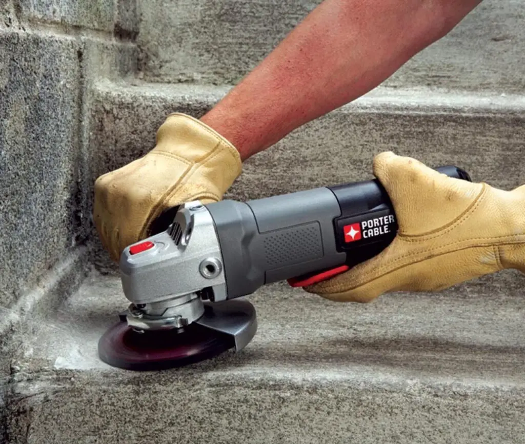 Sand concrete floor with hand sander