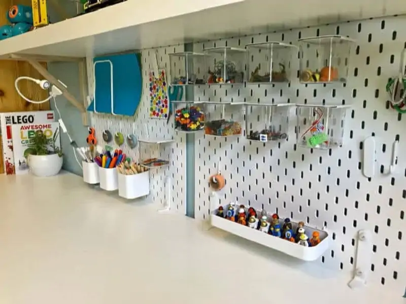 a Pegboard with containers for storing legos