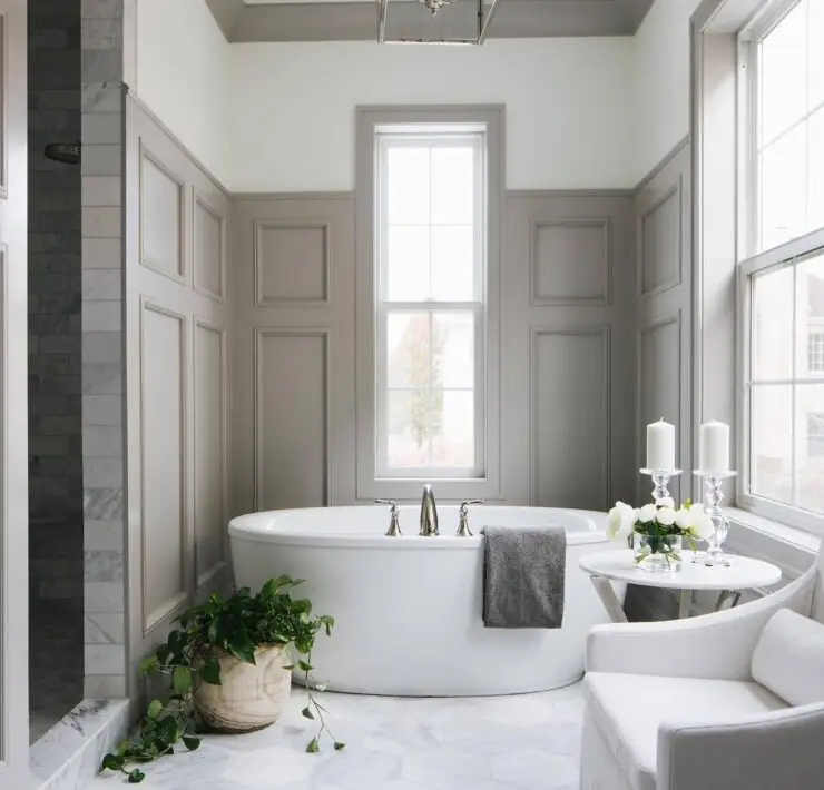 Candles and green plants beside bath tub