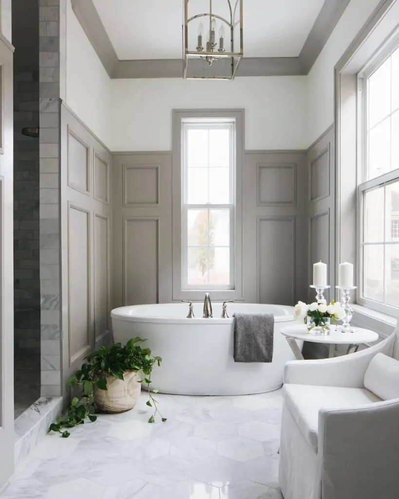 Candles and green plants beside bath tub